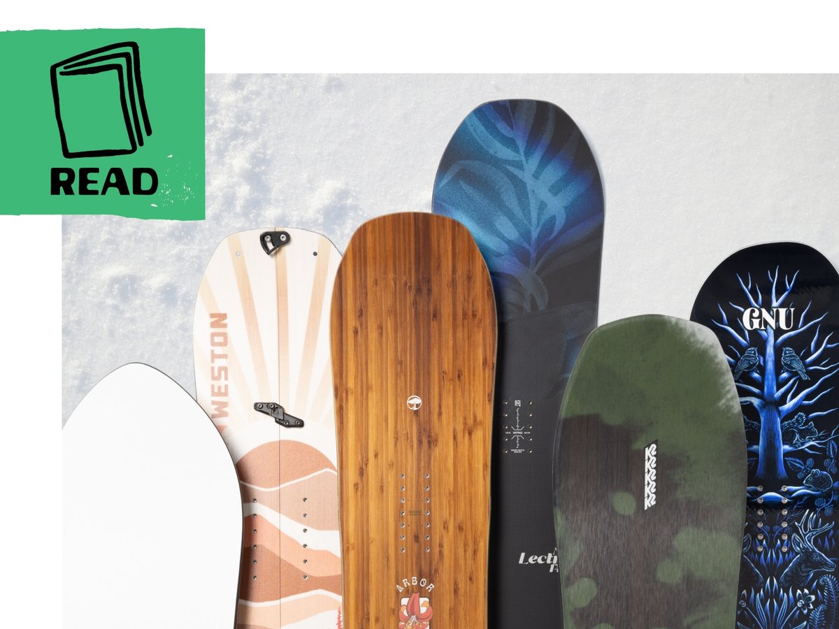 A grip of snowboards staged on snow with overlapping topsheets. 